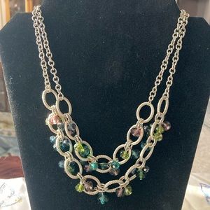 Silvertone double strand collar necklace with faceted rhinestones caged.